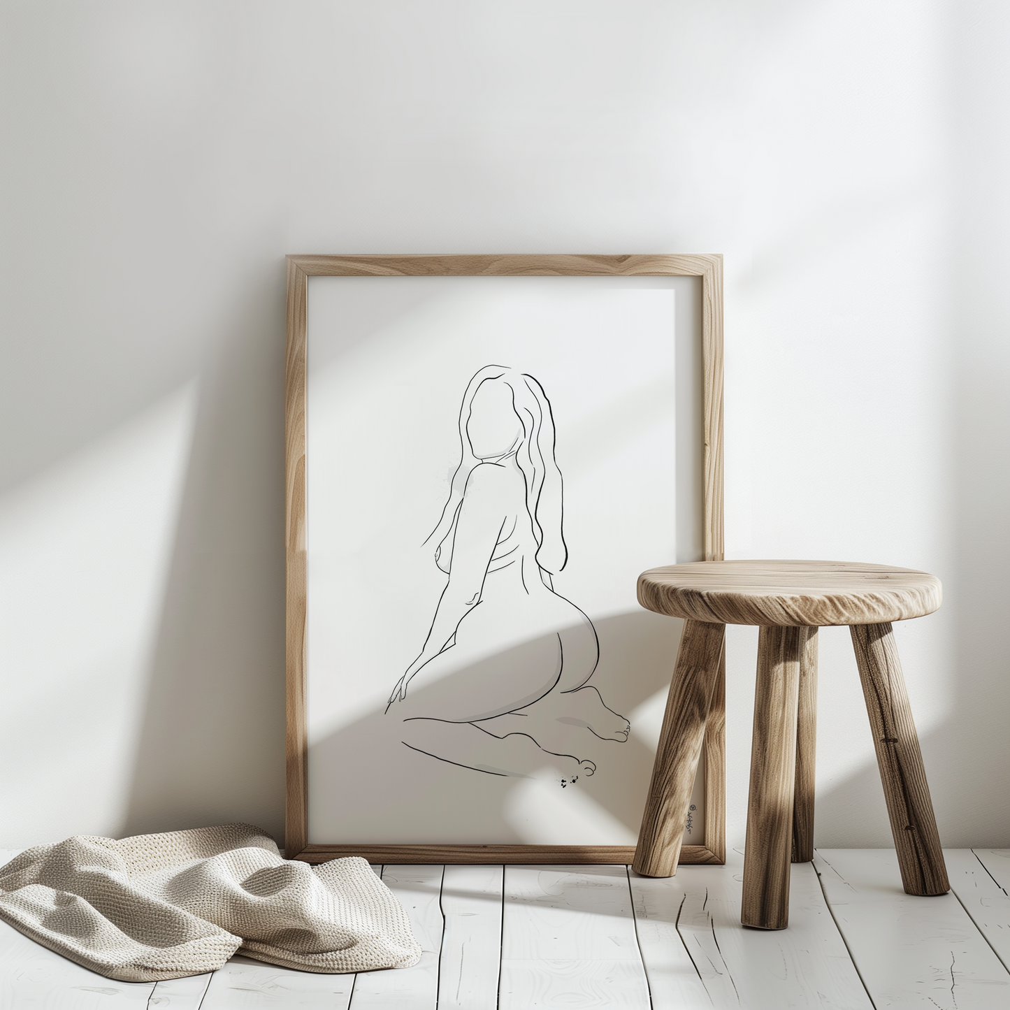 Erotic art illustration displayed in a art frame mockup, showcasing a digital downloadable erotica artwork featuring a minimalist style. The artwork is placed in a bright white room and has a decorative wooden stool in front of it