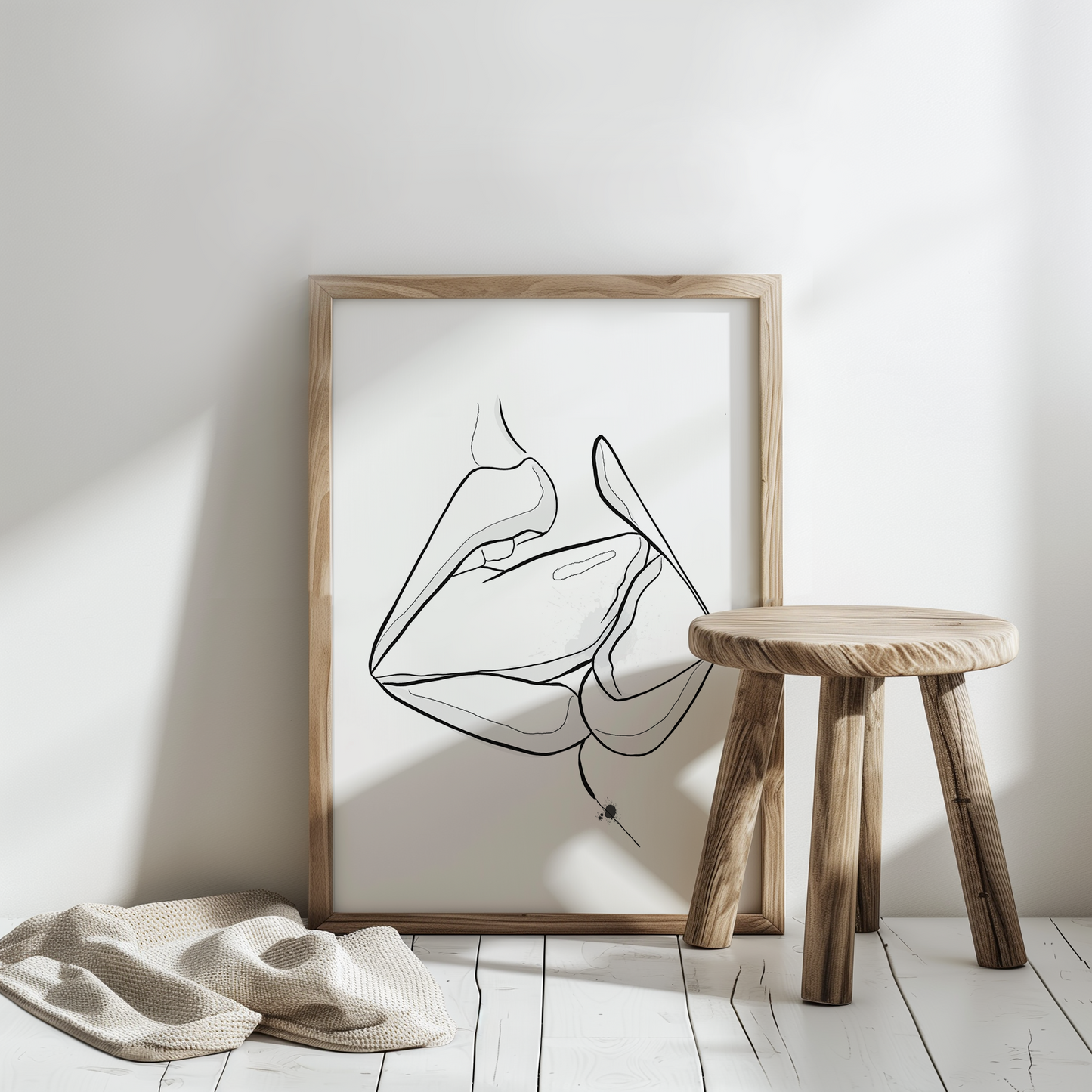 Mockup of downloadable erotic art of two mouths kissing. The erotica art is in a wooden frame, placed in a white room with a natural colored plaid in the white floor