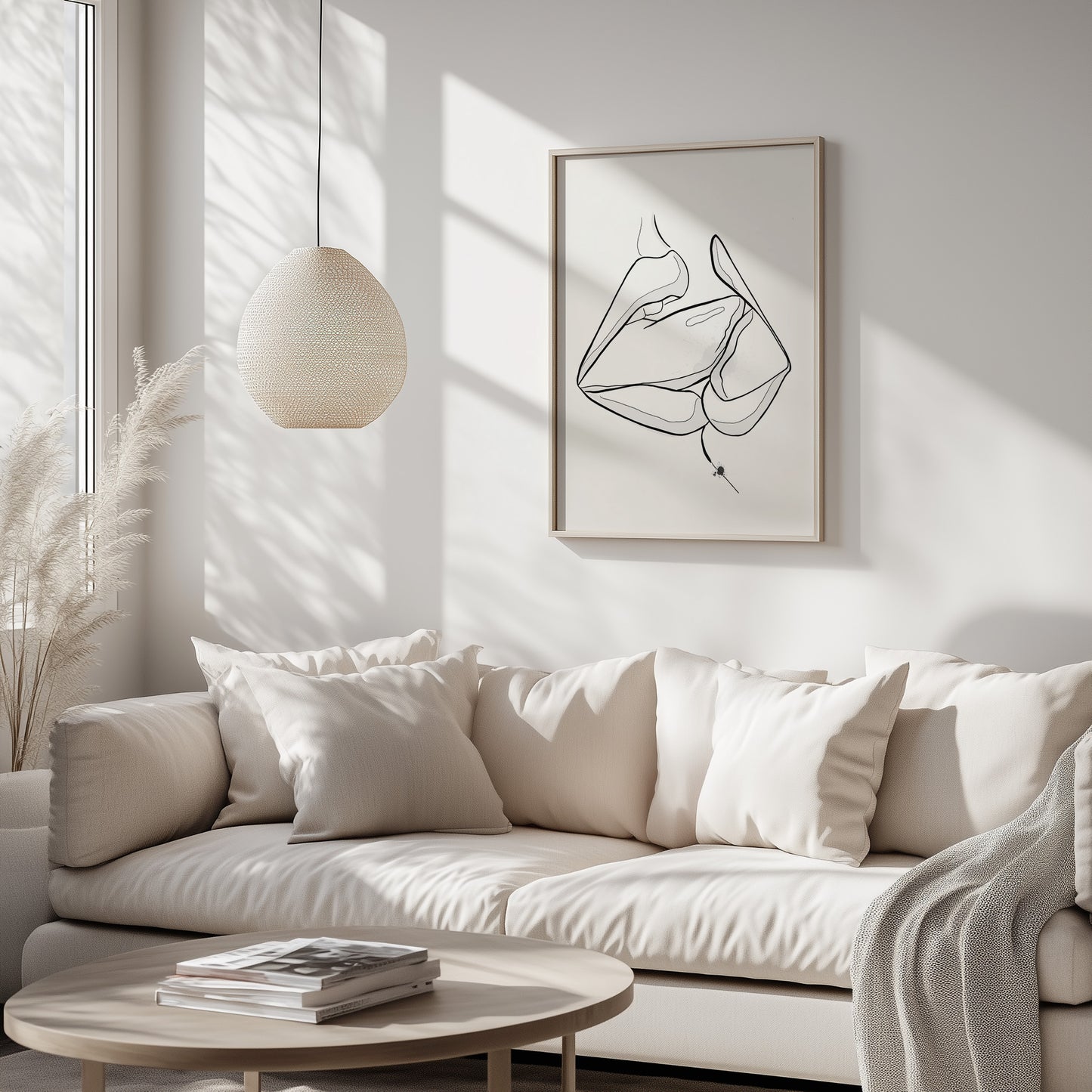 Mockup of downloadable erotic art of two mouths kissing. The erotica art is in a wooden frame, placed in a boho styled white living room. The artwork hangs above a beige sofa.