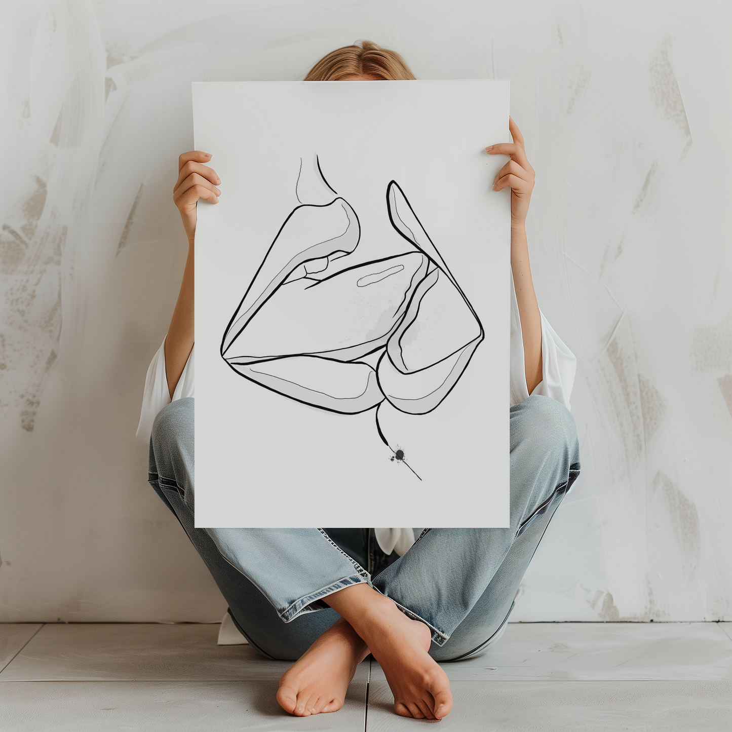 Mockup of a woman holding up a downloadable erotic art of two mouths kissing.