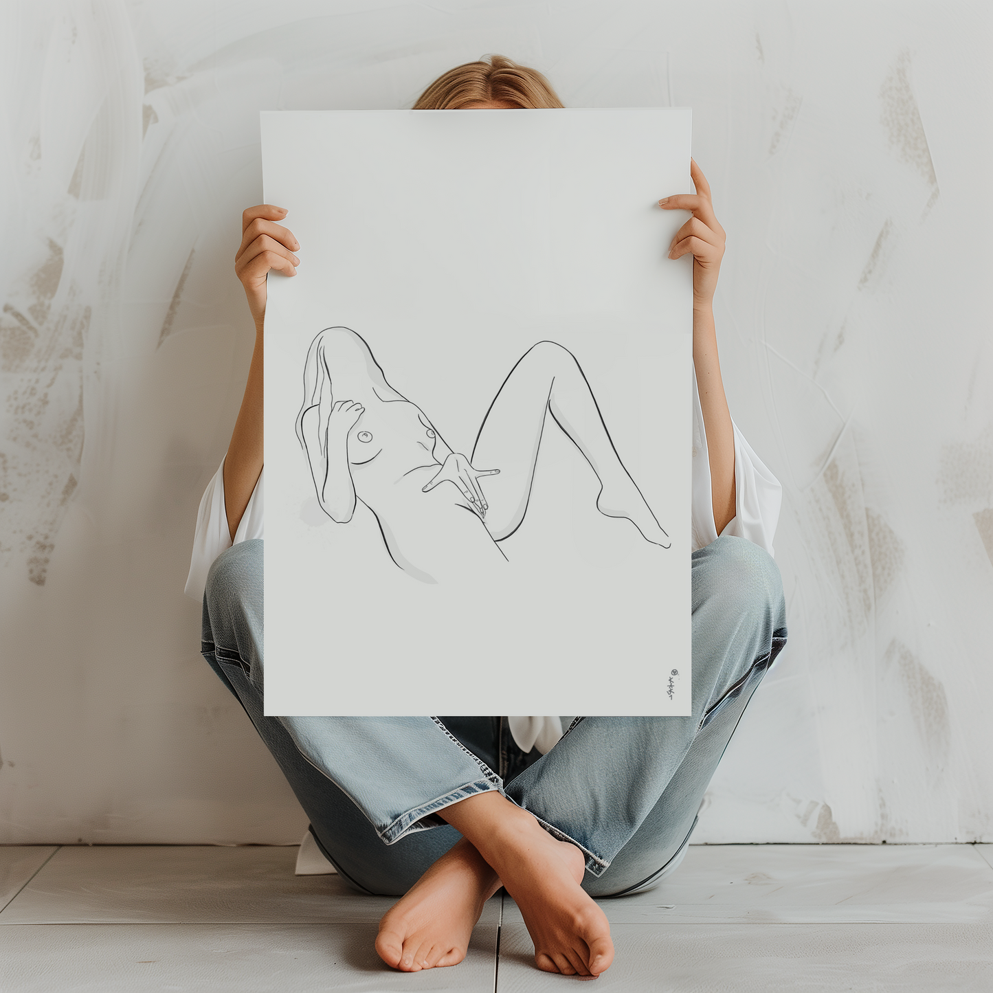 Woman wearing jeans holding up a Abstract erotic art illustration in a photo mockup, available as erotica downloadable file featuring nudes