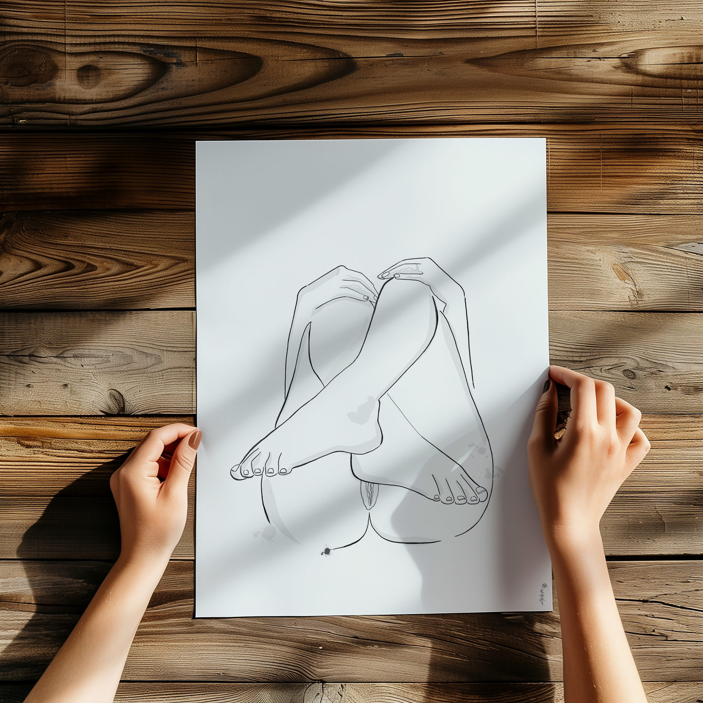 Original erotic art illustration in a framed art print mockup, showcasing abstract minimalist nudes and elegant erotica placed on a wooden table
