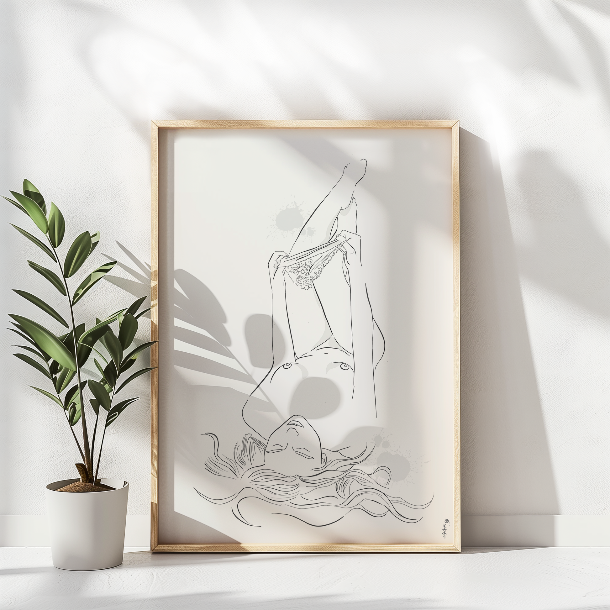 Mockup of an illustration of a nude woman undressing. This erotic art is placed in a natural color wooden frame and leans against a white wall. Next to the frame is a plant
