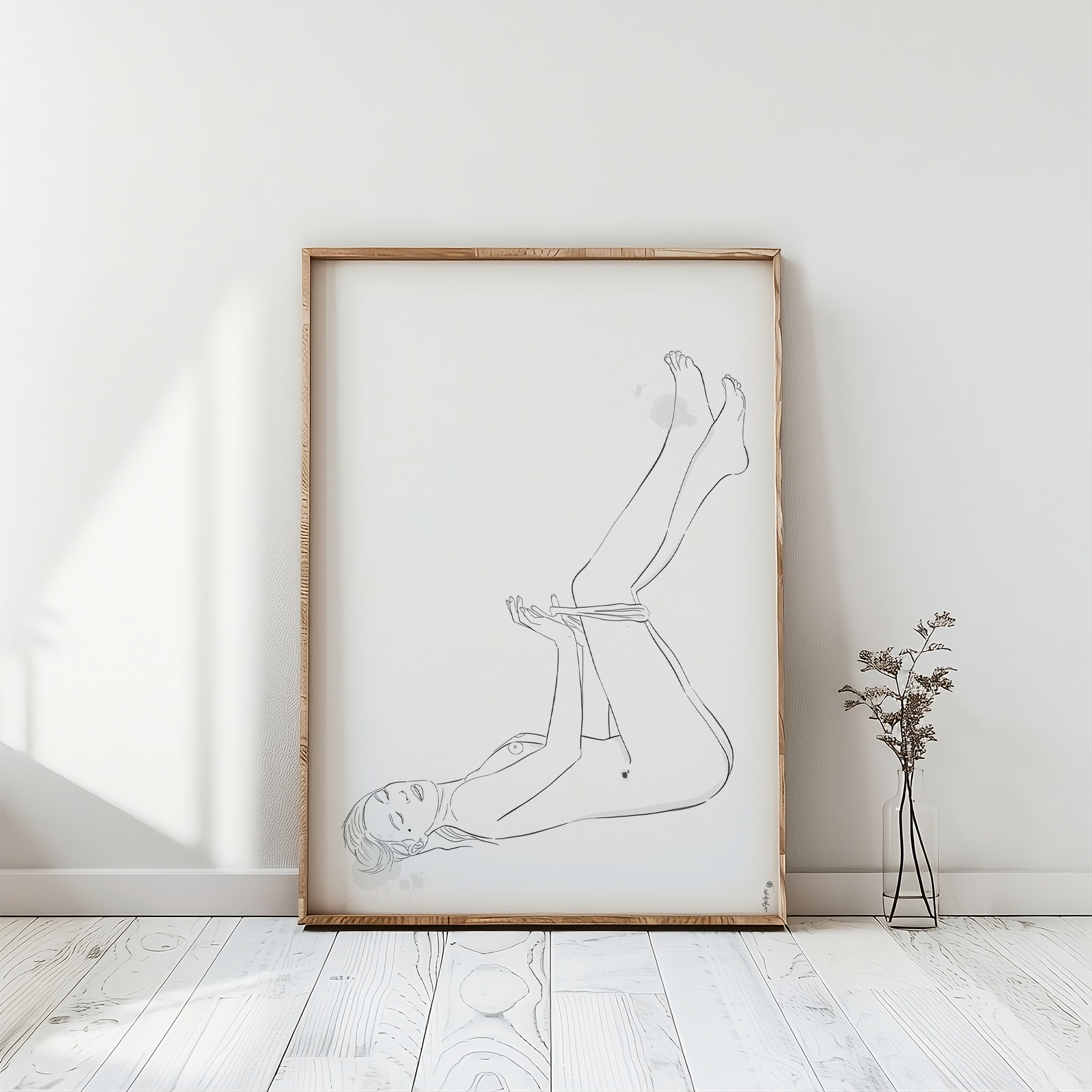a nude female figure illustration placed in a frame. This erotic art is in a light room with a white wooden floor